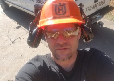 A man wearing an orange helmet and sunglasses.